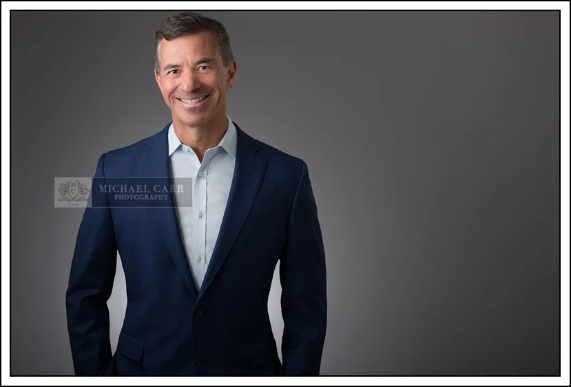 Houston Headshot Photographer Houston professional headshot of a business executive in a blue suit photographed by Michael Carr Photography