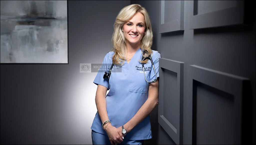 Houston doctor headshot of a physician wearing blue scrubs photographed in Michael Carr Photography's Houston portrait studio.