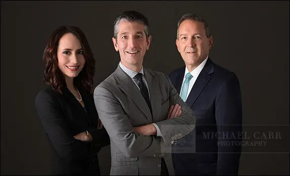 Houston corporate team portrait of three business professionals photographed together in Michael Carr Photography's studio.