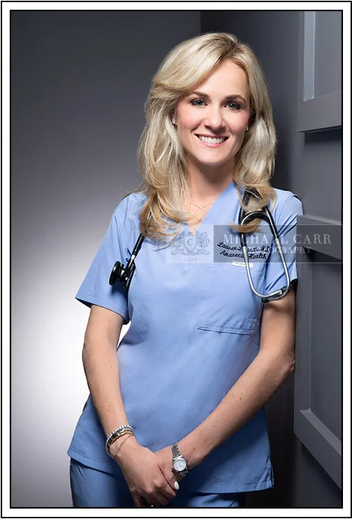 Executive portrait of a female healthcare professional in medical scrubs for personal branding in Houston.