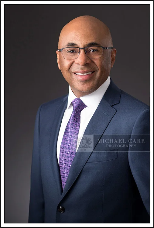 Classic corporate headshot of Houston businessman in navy suit