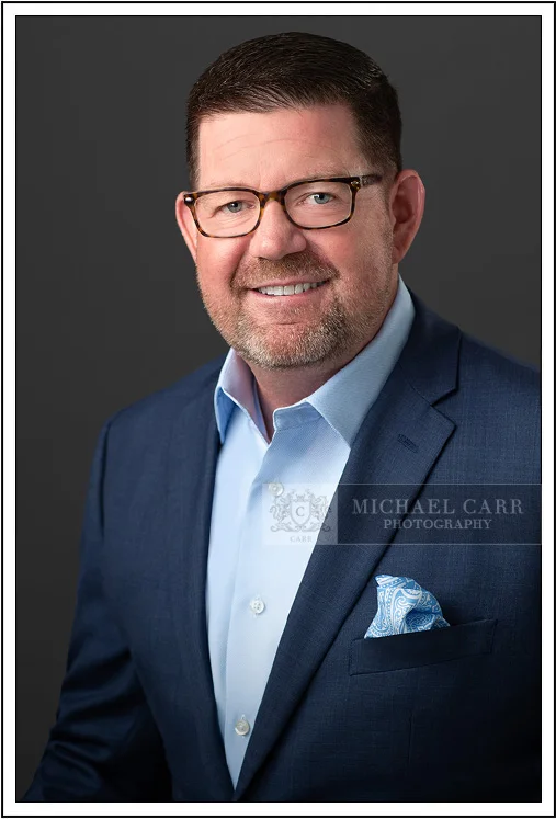 Classic corporate headshot of Houston professional man in blue suit
