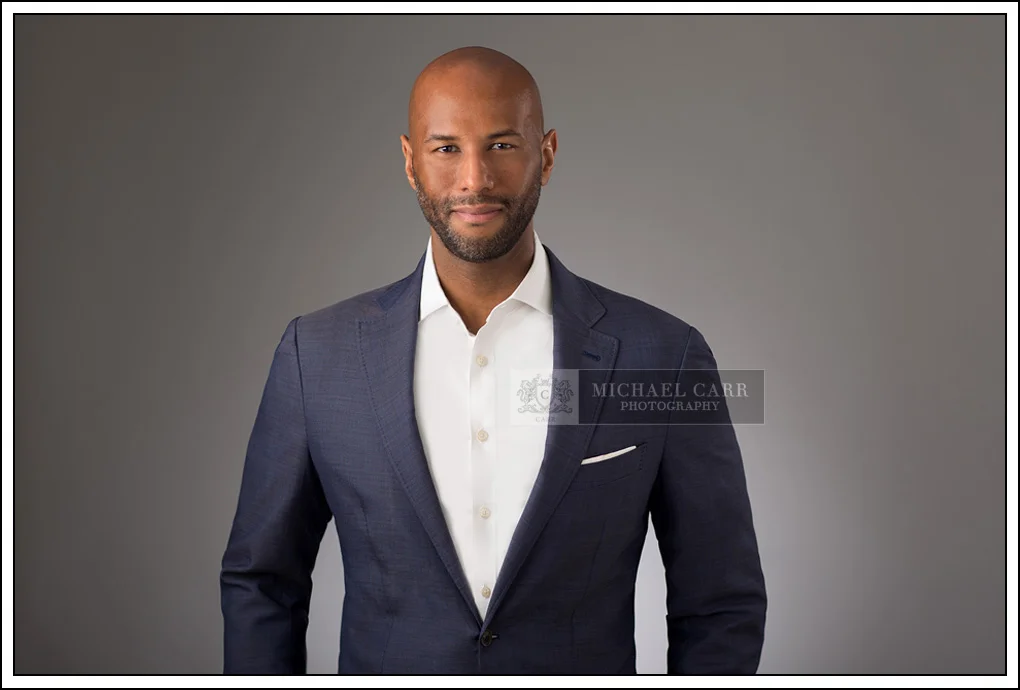 Houston Headshot Photographer Modern executive headshot of a Houston business professional wearing a navy blazer for corporate branding.