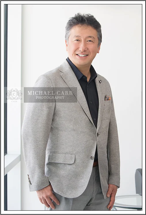 Houston Headshot Photographer Houston on-location executive portrait of businessman in gray jacket